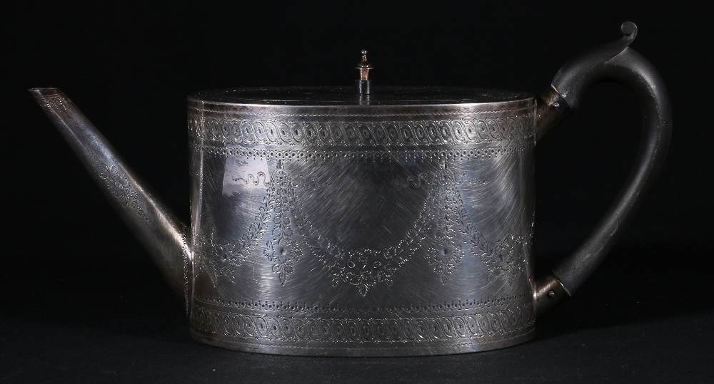 Victorian silver teapot of oval form with garland engraved decoration,