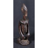 Carved African seated female fertility figure with elongated neck and flattened face,