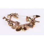 9ct gold charm bracelet with sixteen charms including a 1912 half sovereign,
