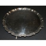 George V silver salver with pie crust edge raised on four supports, Chester 1911, HEB FEB,