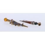Two Scottish brooches of dirk form set with agate and having Cairngorm finials, 5cm and 4cm.
