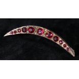 9ct gold crescent moon brooch set with eleven pink rubies flanked by diamond chips, approx 4.