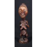 Congolese Luba standing female figure with hands across the pendulous breasts, elongated face,