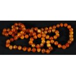 Amber single strand necklace, with uniform beads measuring approximately 10mm, 95g 61cm overall.