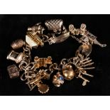 9ct gold curb link charm bracelet with fifteen dependant charms, 33.