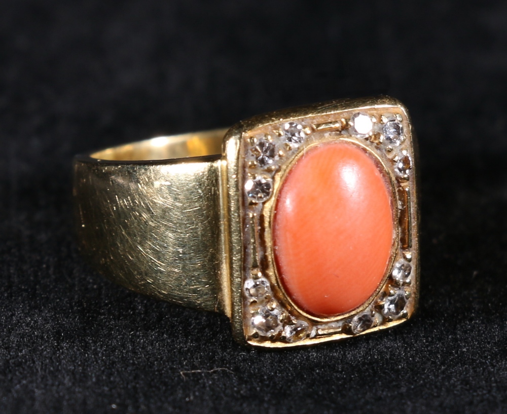 18ct gold coral and diamond set ring with central matt cabochon oval coral flanked by twelve