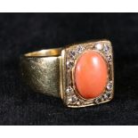 18ct gold coral and diamond set ring with central matt cabochon oval coral flanked by twelve