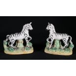 Pair of Staffordshire figures of Zebra, on rustic oval bases, 12cm.