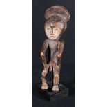 Congolese Mbole figure seated with hands on thighs,