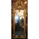 19th century French gilt gesso pier glass mirror with substantial foliate frame and arched crest.