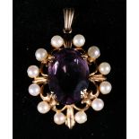 9ct gold openwork pendant set with central faceted oval amethyst encircled by twelve seed pearls. 6.