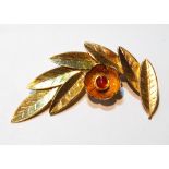 Middle Eastern gold spray brooch with coral-set flower, '18k'. Condition Report 13.