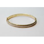 18ct gold hinged bangle with white gold centre. Condition Report 6.