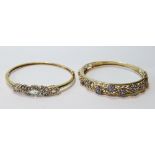 Two 9ct gold hinged bangles with tanzanite.