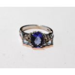 Tanzanite ring with diamond-set shoulders, each with three brilliants, in 18ct white gold.