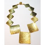 Gold necklet with textured rectangular panels in sizes.