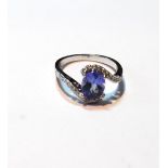 Tanzanite and diamond crossover style ring in 18ct white gold.