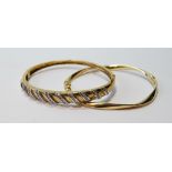 9ct gold hinged bangle with diagonal bands of small diamonds and another, waved.