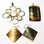 Gold whorl pendant, another of panel form, and a pair of square drop earrings.