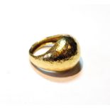 Textured gold dress ring of domed form, '.750'.