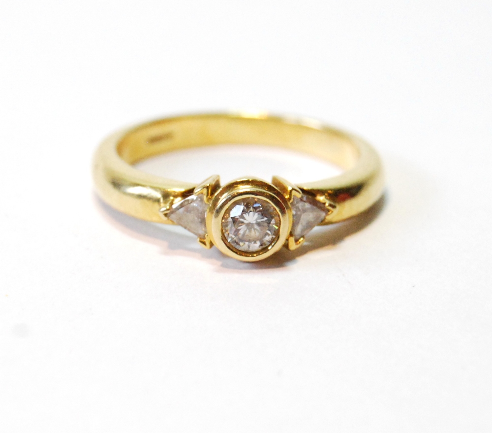 Diamond solitaire ring with collet-set brilliant and shoulders, in 18ct gold.