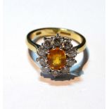 Diamond and yellow sapphire oval cluster ring in 18ct gold.