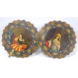 Pair of Victorian mother of pearl inlaid papier maché fan panels, lacking handles, 25cm diameter.