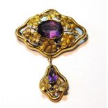 Victorian gold embossed brooch of waved lozenge shape with drop dependant, set with two amethysts.
