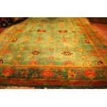 Large Ushak style carpet with garland and floral design on a faded blue field, 420cm x 324cm.