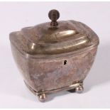 White metal tea caddy of boat shape with reeded rims raised on four ball supports,