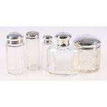 Group of five assorted silver topped glass toilet jars, largest 9.5cm.