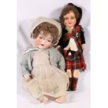 Two German bisque head dolls one in Highland tartan dress with head stamped Germany 590 A5/0X M