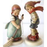 Two Goebel Hummel figures of a boy and girl.