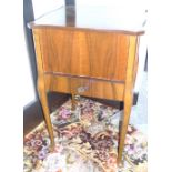 Burr walnut sewing cabinet with hinged lid and drawer, on cabriole legs.