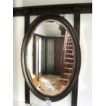 Large oval mahogany framed wall mirror with beaded edge, 99cm x 68.5cm.