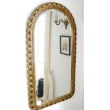 Carved gilt framed dome-top wall mirror with bevelled glass.