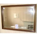 Reproduction walnut and gilt wall mirror, 81cm x 56cm.