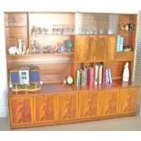 Mahogany wall cabinet with six cupboards and an arrangement of shelves, 203cm.