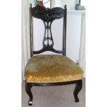 Mahogany framed Edwardian nursing chair with splat back, upholstered in gold coloured fabric.