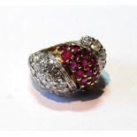 Cocktail ring of early 20th century style with convex pavé-set rubies flanked by diamonds, in gold.