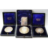 Three silver medals, various, cased, and a silver vesta case.