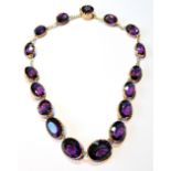 Antique gold necklace of sixteen graduated oval amethysts and a similar circular snap.