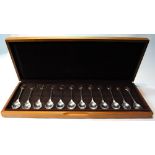 Set of twelve silver spoons, R.S.P.B., each with gilt bird finial, 10oz, cased.