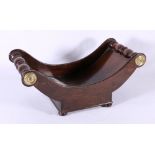 19th century brass mounted mahogany cheese coaster or truckle raised on bun feet, 19cm x 4.3cm.