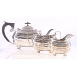 Silver three piece teaset, of oblong form, with gadrooned borders, raised on bun feet, 1215g gross.