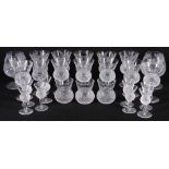 Suite of twenty-five cut glass drinking glasses with engraved thistle shaped bowls and star cut
