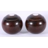 Pair of Victorian silver mounted walnut bowling balls, engraved with initials and dates.