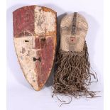 Songye stylised mask with incised and painted decoration and grass beard,