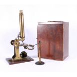 19th century lacquered brass monocular microscope, with approximately twenty-four specimen slides,