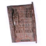 Dogon carved wood door panel carved in relief with multiple figures and animals, 74cm x 46cm.